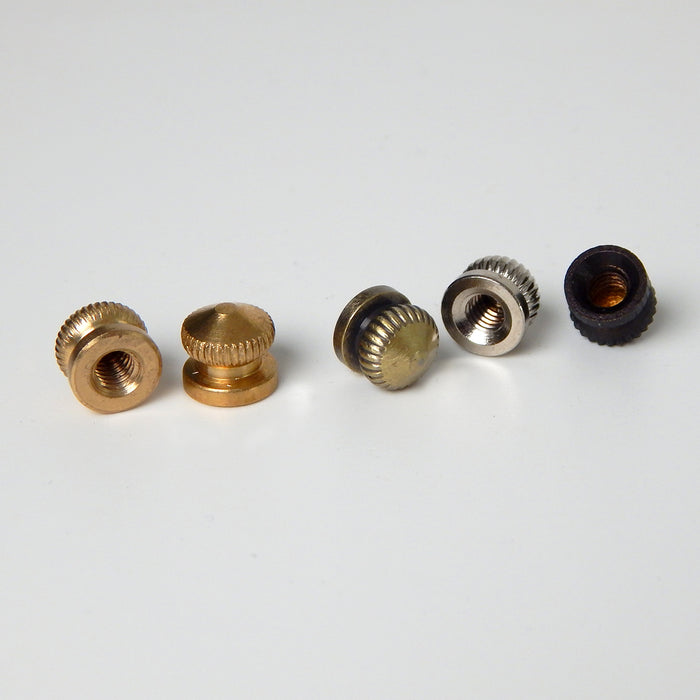 Underside view of 8/32 female thread knurled brass thumbnuts, showing the interior threading and seating for light fixture installation.